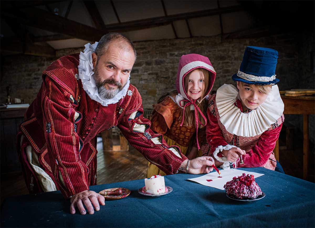 Tutor and children dressed in Tudor costume 