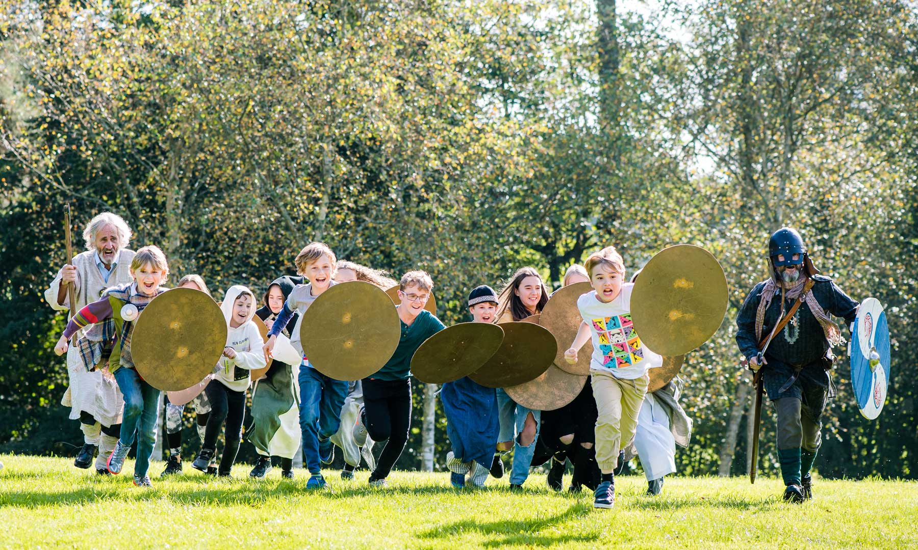 Children dressed as Celtic warriors making a battle charge