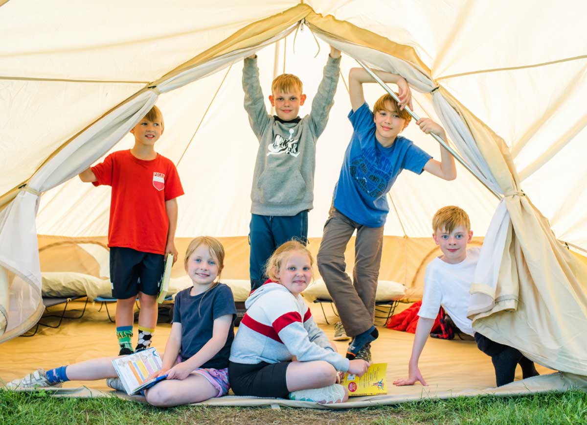 Children inside a summer camp bell tent