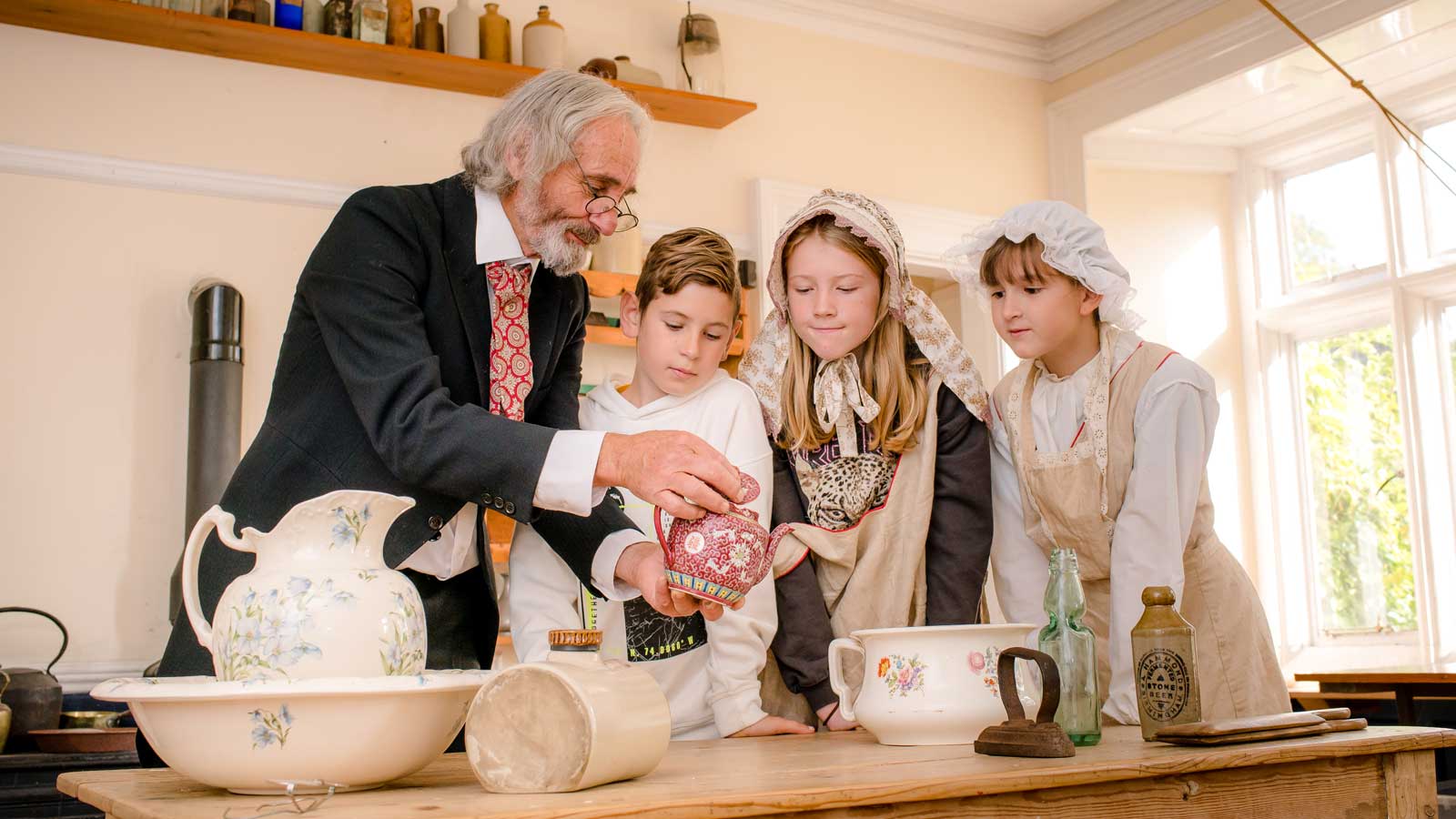 Children examining Victorian Teapot