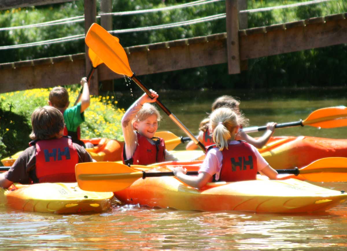 Children kayaking on Hooke Court's lake